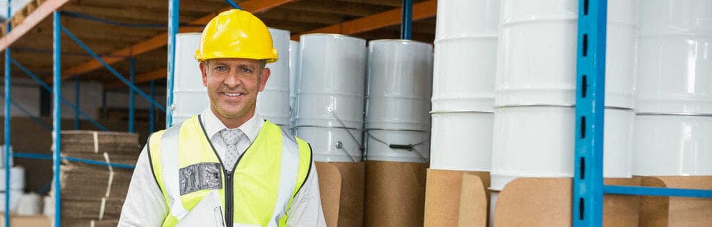 Smiling Construction Worker in Warehouse