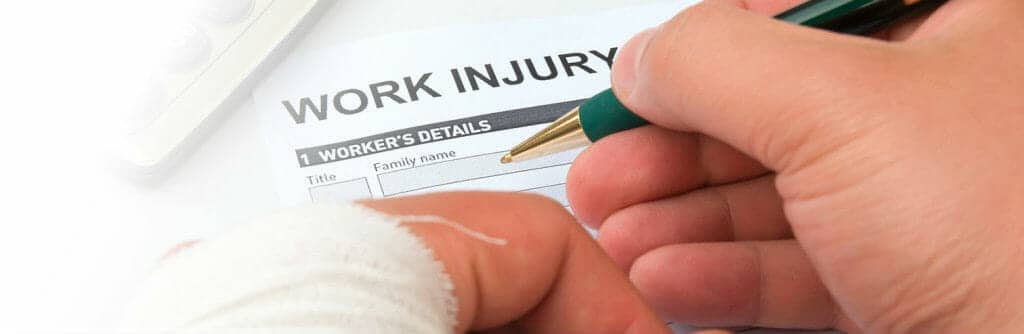 Person Filling Out Work Injury Form From Personal Injury Attorney